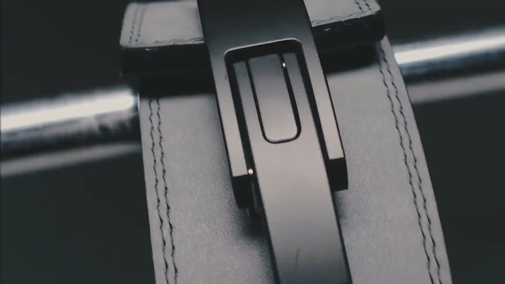 Close-up of a lever belt buckle on a leather belt